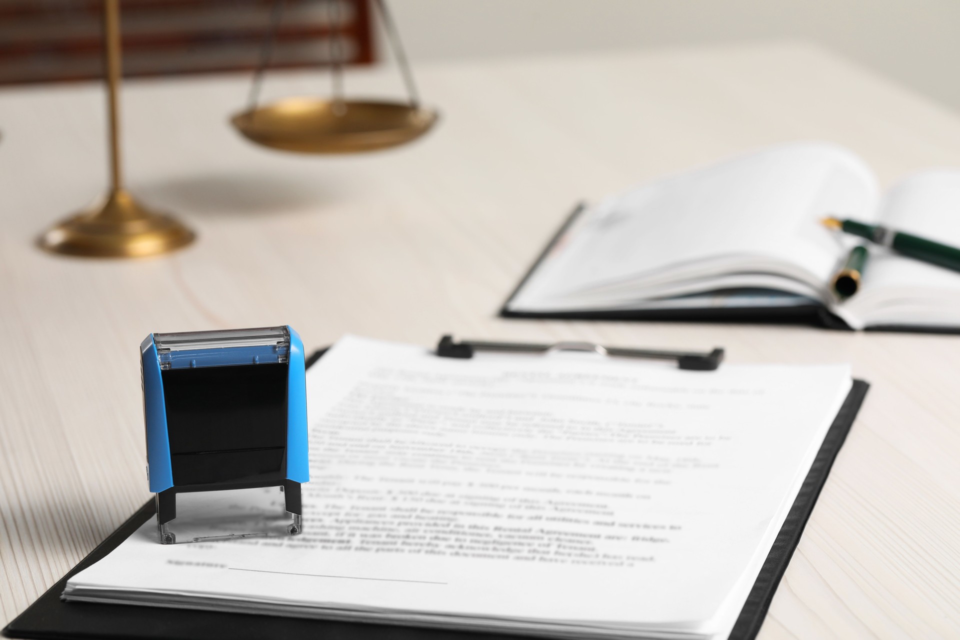 Notary contract. Documents and stamp on white wooden table